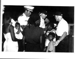 Interdiction of Haitians by U.S. Coast Guard, officials talk to women and children, October 1981. Source: United States Citizenship and Immigration Services History Office and Library. Interdiction of Haitians by U.S. Coast Guard, officials talk to women and children, October 1981. Source: United States Citizenship and Immigration Services History Office and Library.