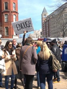 People marching. A sign reads "Enough"